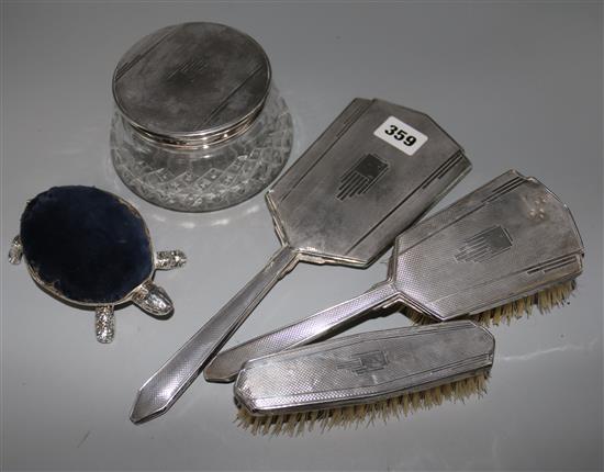 A matched 4-piece silver mounted dressing table set and a silver tortoise table bell (incomplete).